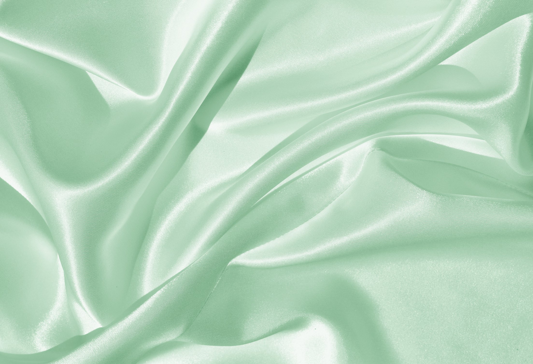 The texture of the satin fabric of green color for the background